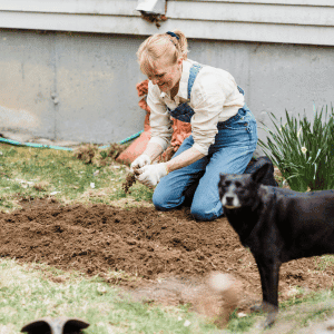 woman gardening with dog in Durham, NC
