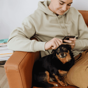 Why the kid next door is not a pet sitter - kid on phone with dog in Durham, NC